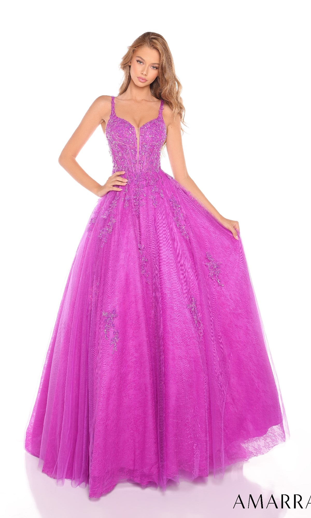 A young woman poses against a white background wearing the Amarra 88219 Lace Prom Ball Gown, a floor-length bright purple A-line dress with beaded embellishments, thin straps, and a fitted bodice.